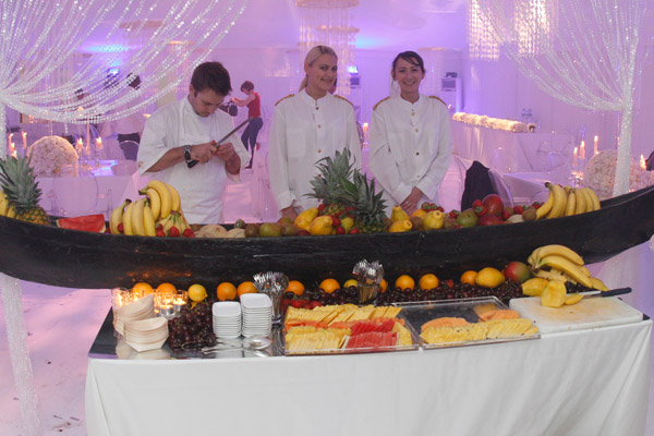 luxury fruit buffet chefs cutting slices silver trays Jacqueline kennedy process creating luxury event